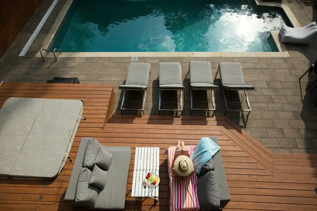 Gray loungers by a pool on a modern outdoor terrace