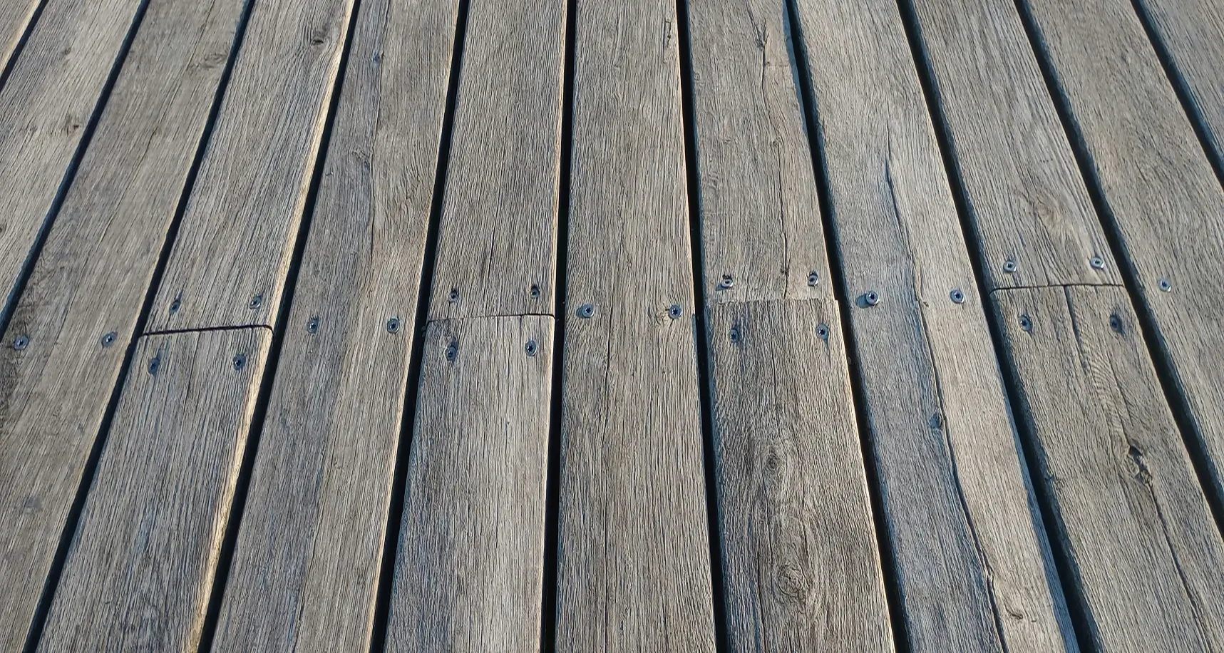 Deck boards being fastened with two screws at each joist